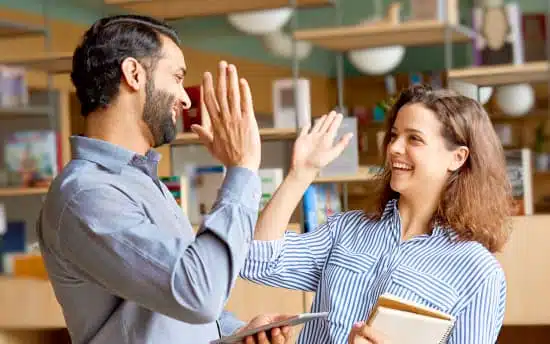 Two business professionals high-fiving each other